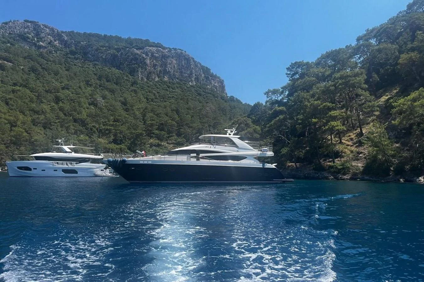 a couple of boats on the water aboard PRINCESS I Yacht for Sale