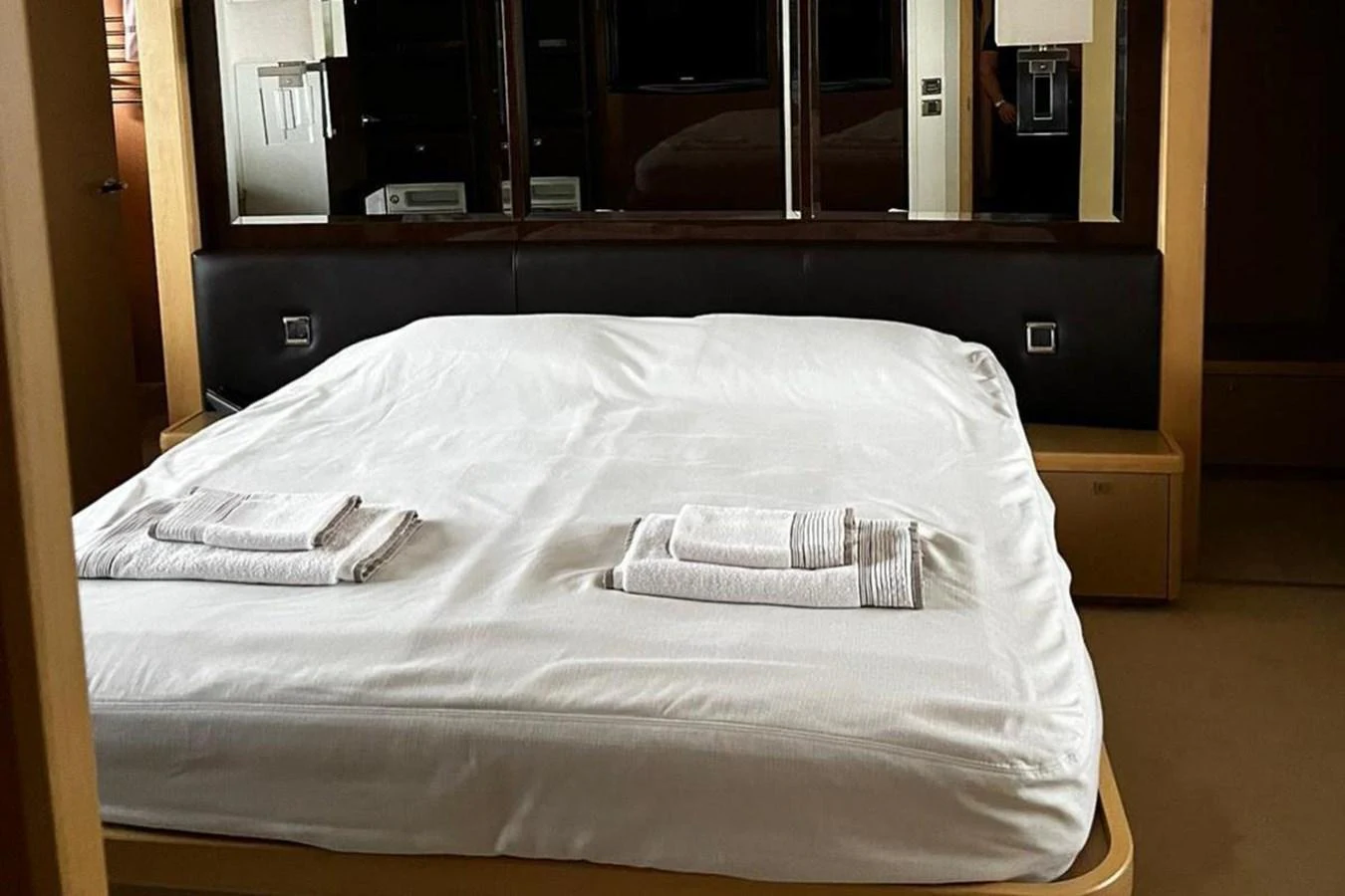 a white bed with a white sheet aboard PRINCESS I Yacht for Sale
