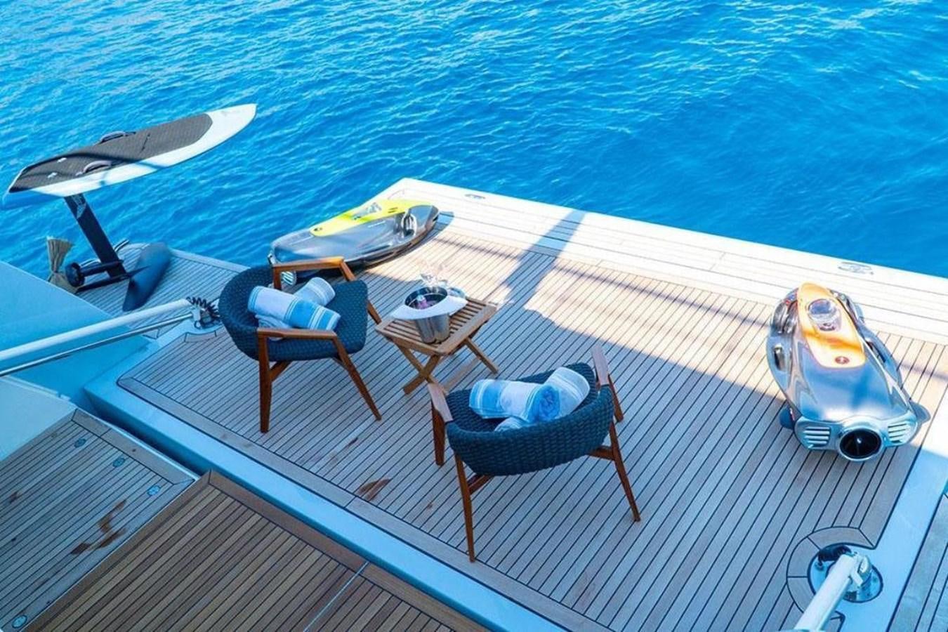a deck with chairs and a table on it aboard CUSTOM LINE  97 Yacht for Sale