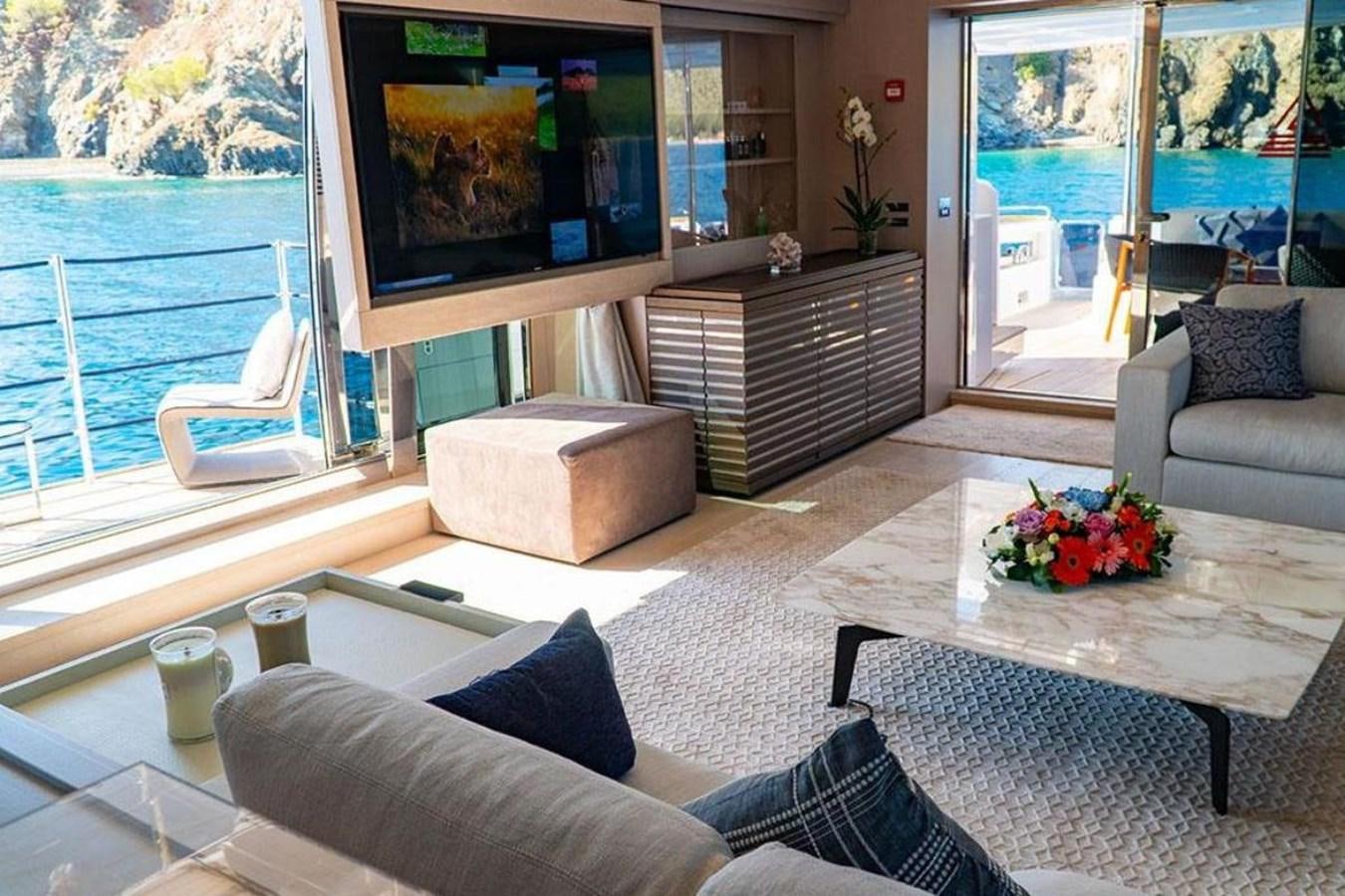 a living room with a large tv aboard CUSTOM LINE  97 Yacht for Sale