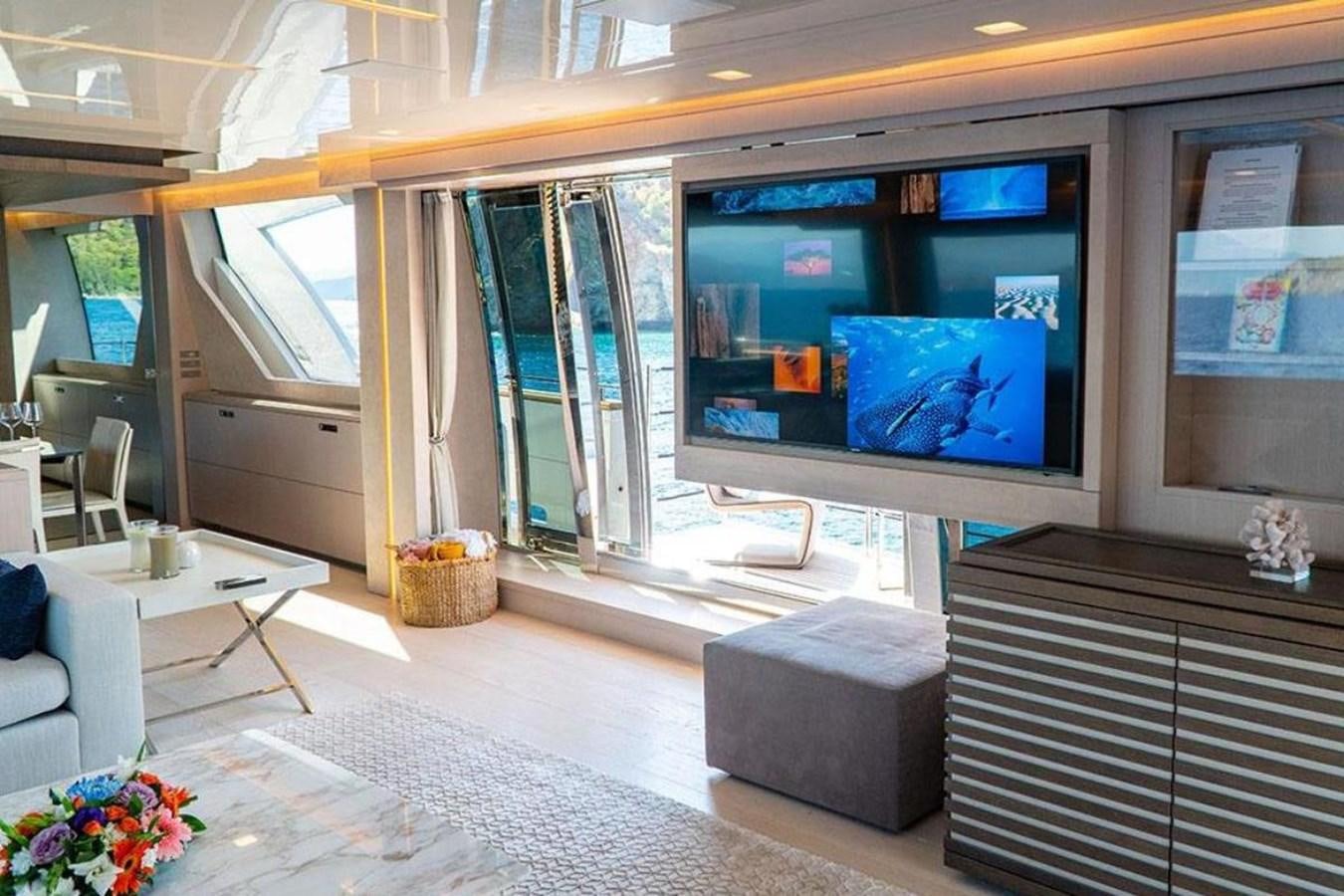 a room with a tv and a couch aboard CUSTOM LINE  97 Yacht for Sale