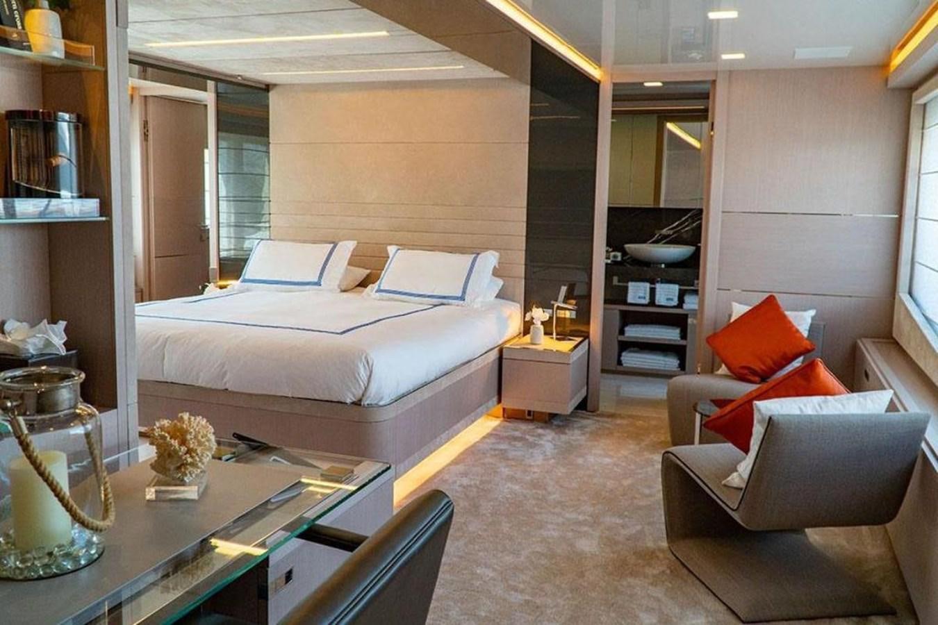 a room with a bed and a couch aboard CUSTOM LINE  97 Yacht for Sale