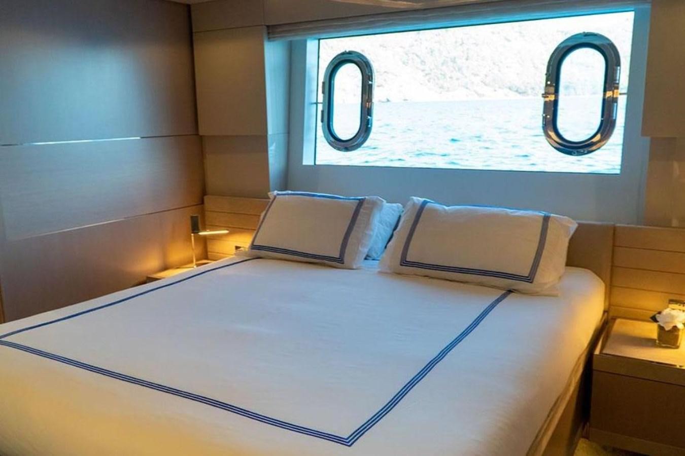 a bed with a blue sheet aboard CUSTOM LINE  97 Yacht for Sale