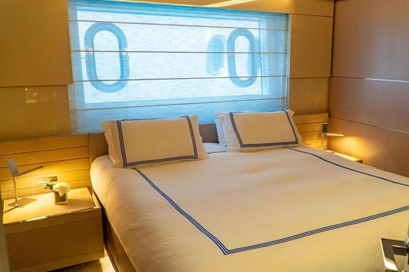 a bed with a white sheet and pillows on it aboard CUSTOM LINE  97 Yacht for Sale