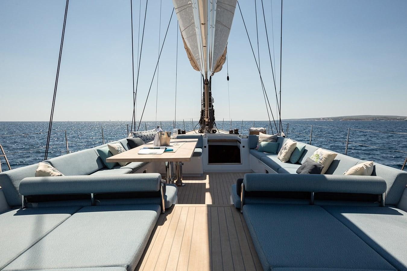 a deck with a view of the ocean and a boat aboard FRIDAY Yacht for Sale