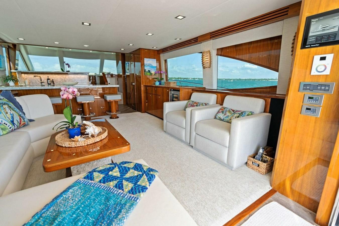 a living room with a table and couches aboard MANA Yacht for Sale