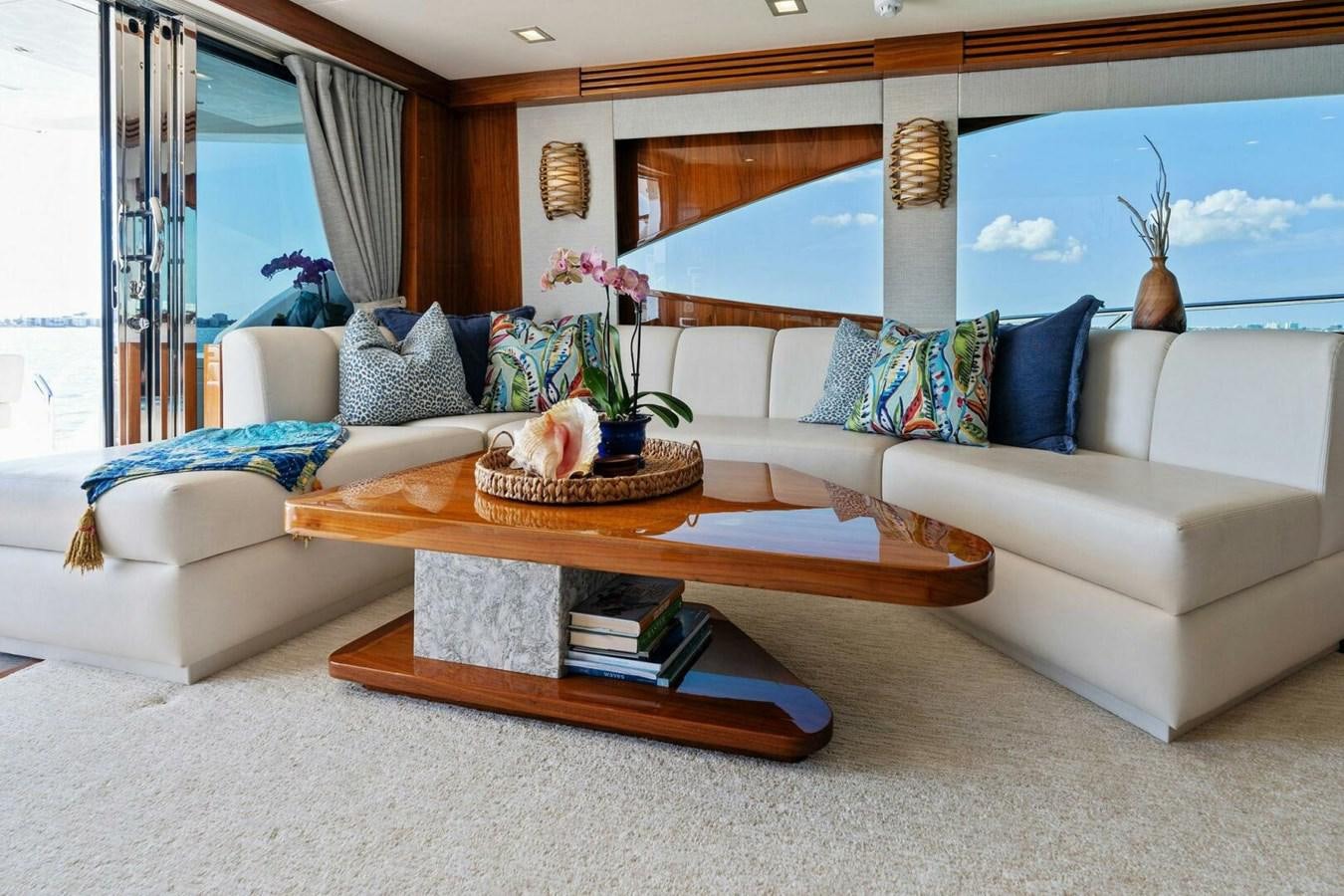 a living room with a couch and a coffee table aboard MANA Yacht for Sale