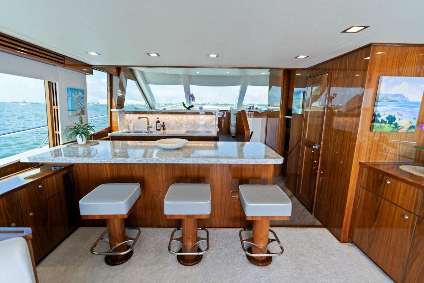 a kitchen with wooden cabinets aboard MANA Yacht for Sale