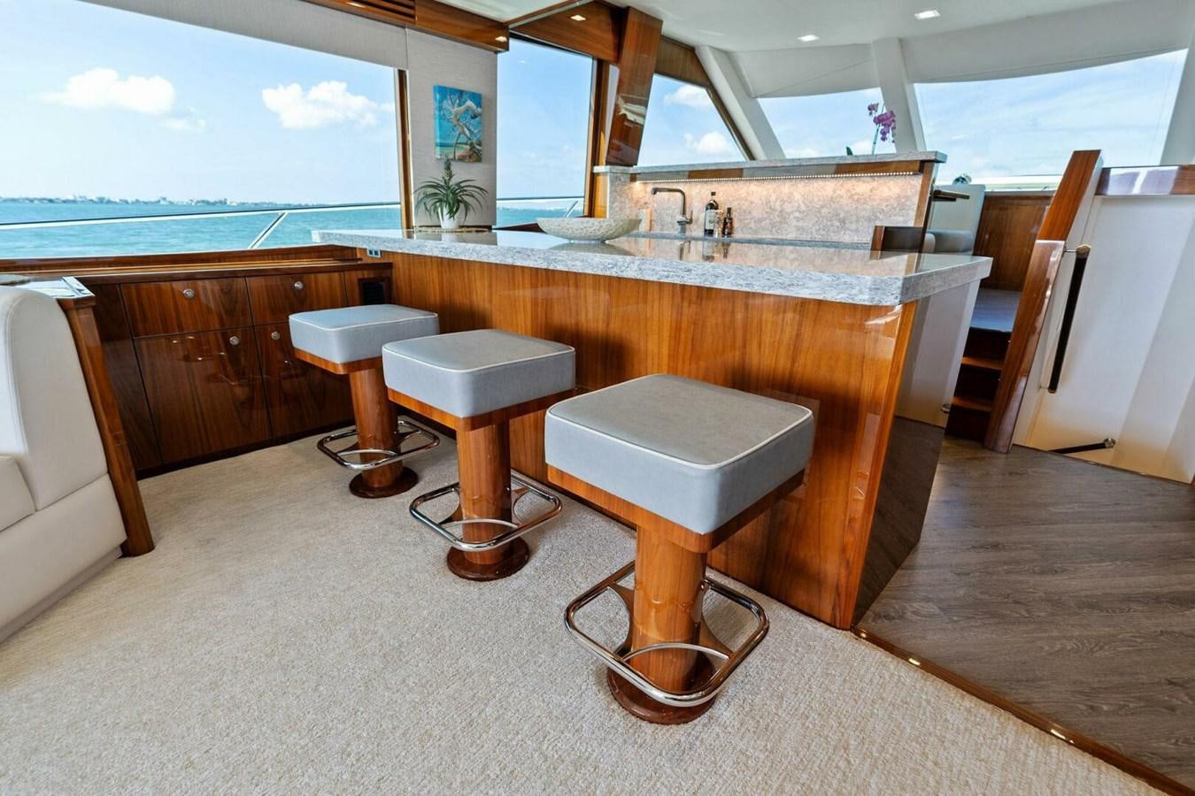 a bathroom with stools and sinks aboard MANA Yacht for Sale