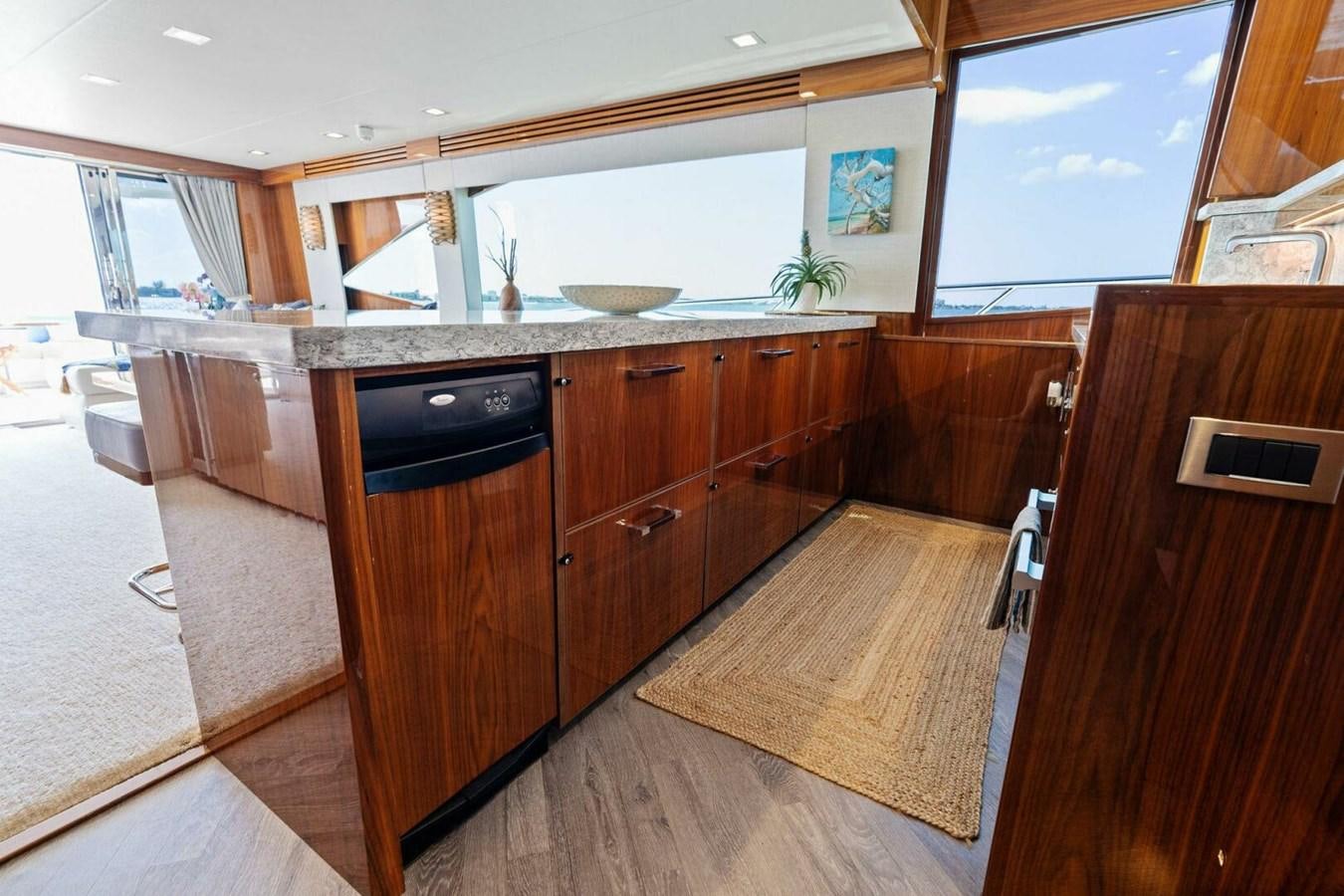 a kitchen with wooden cabinets aboard MANA Yacht for Sale