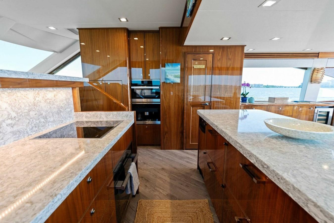 a kitchen with wooden cabinets aboard MANA Yacht for Sale