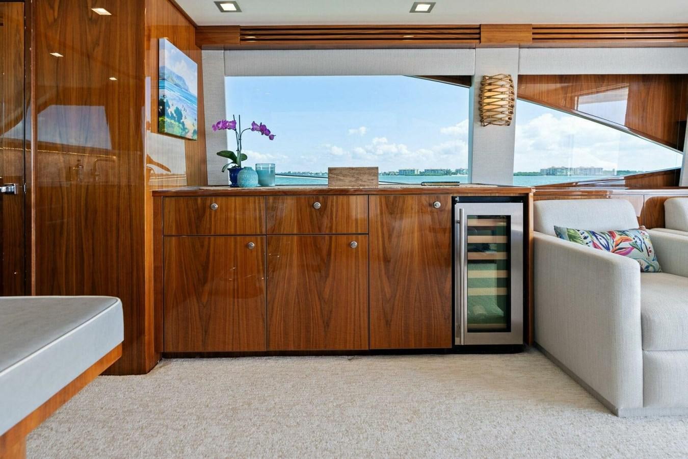 a room with a couch and a table and a window aboard MANA Yacht for Sale