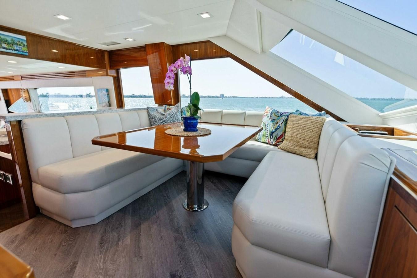 a living room with a couch and a table aboard MANA Yacht for Sale