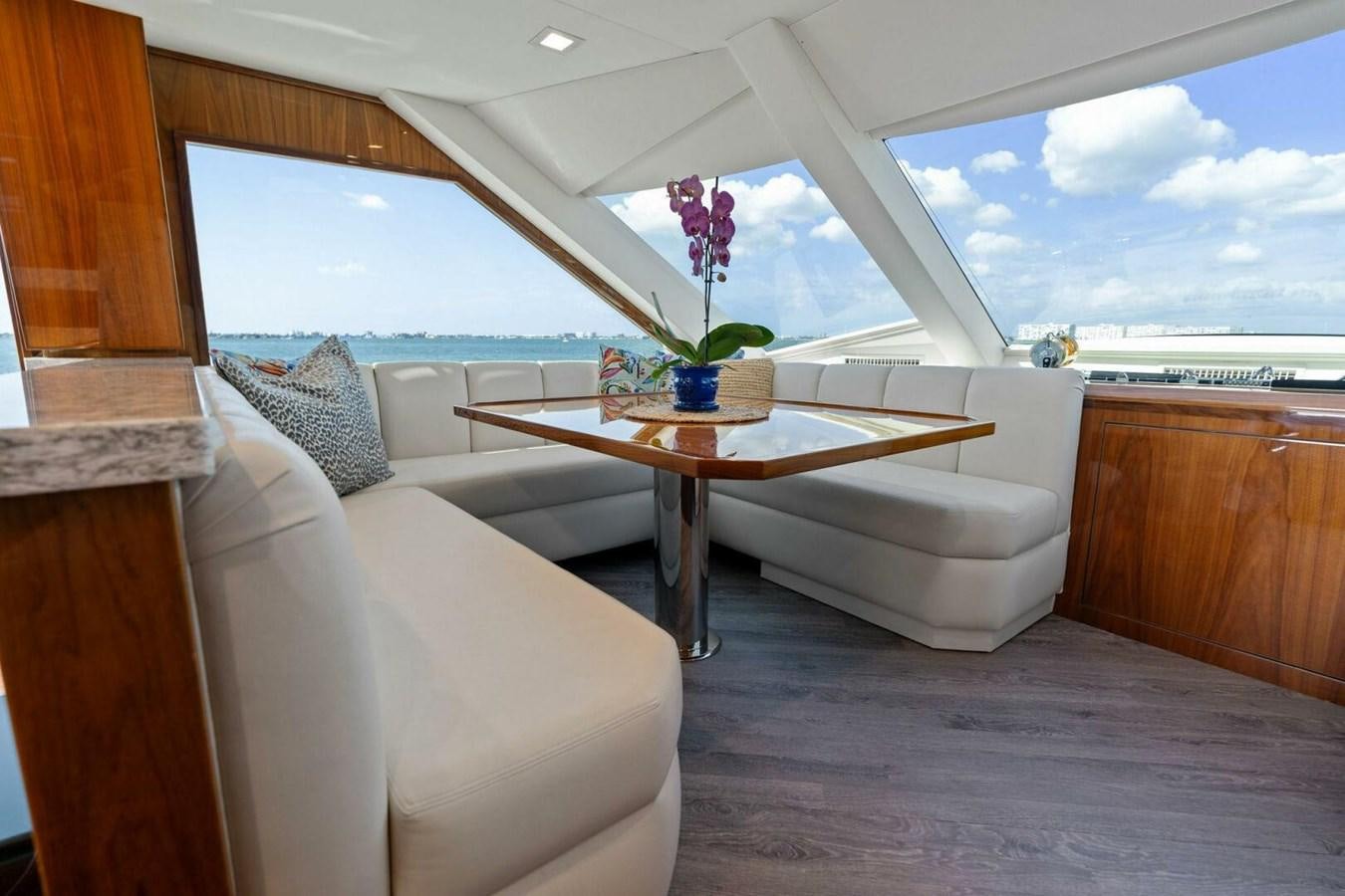 a room with a table and couch aboard MANA Yacht for Sale
