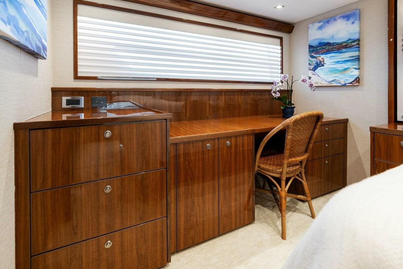 a wooden desk with a chair aboard MANA Yacht for Sale