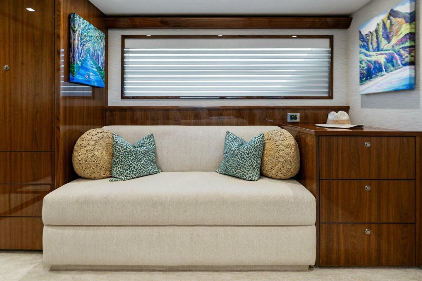 a couch with pillows on it aboard MANA Yacht for Sale