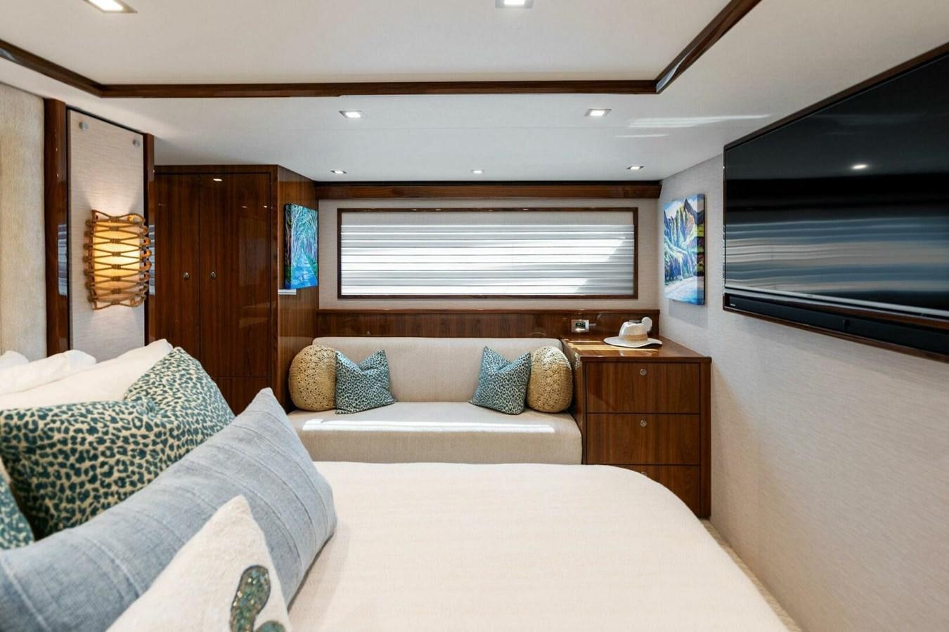 a bedroom with a bed and a television aboard MANA Yacht for Sale