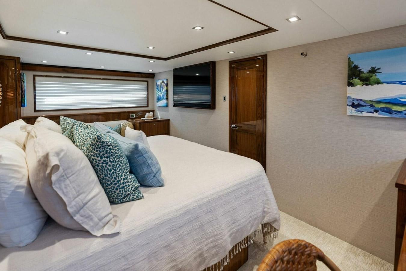 a bedroom with a bed and a television aboard MANA Yacht for Sale