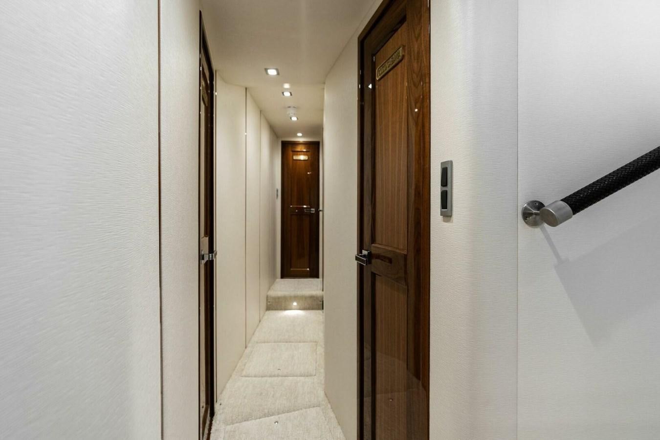 a hallway with doors aboard MANA Yacht for Sale
