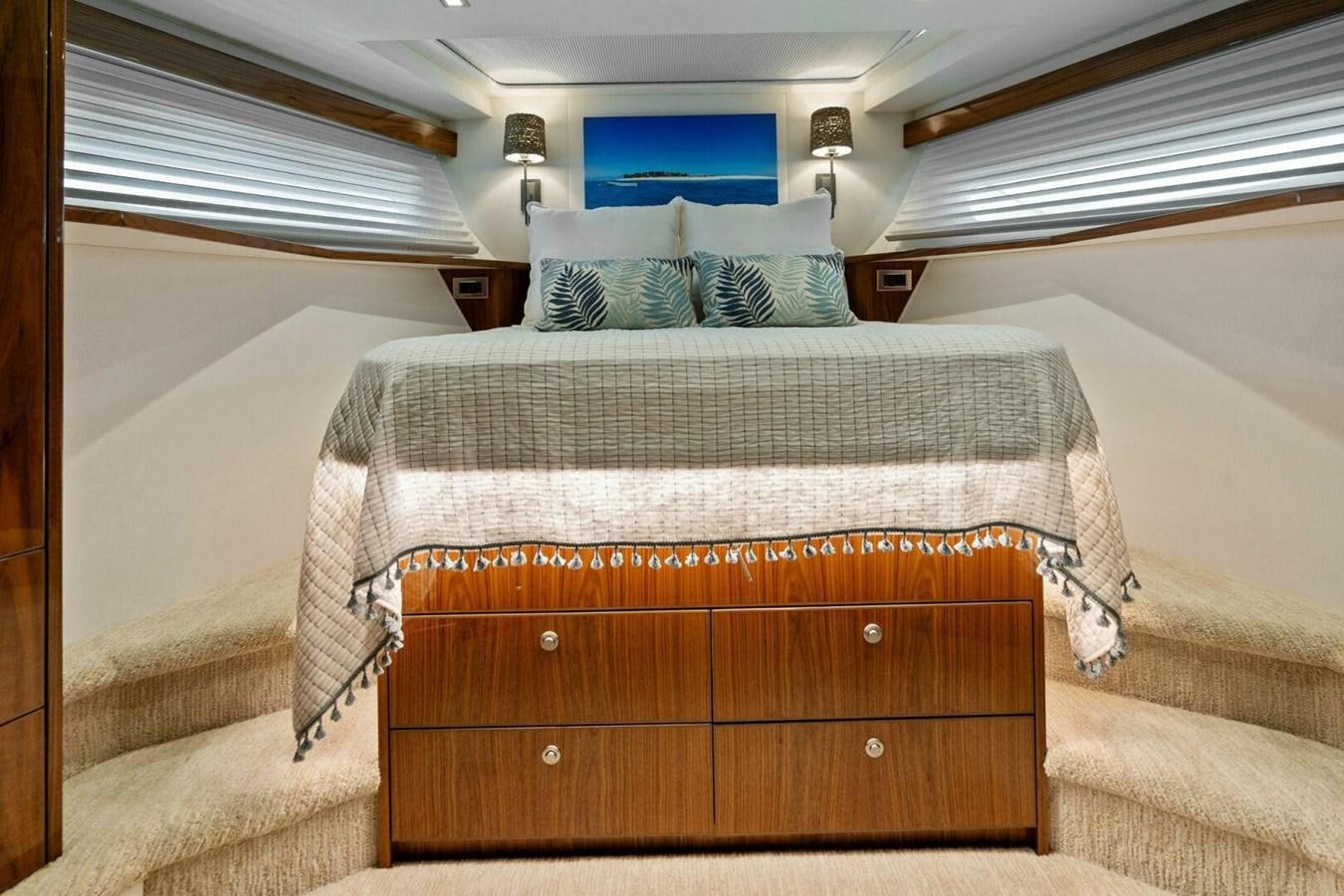 a bed with a wooden headboard aboard MANA Yacht for Sale