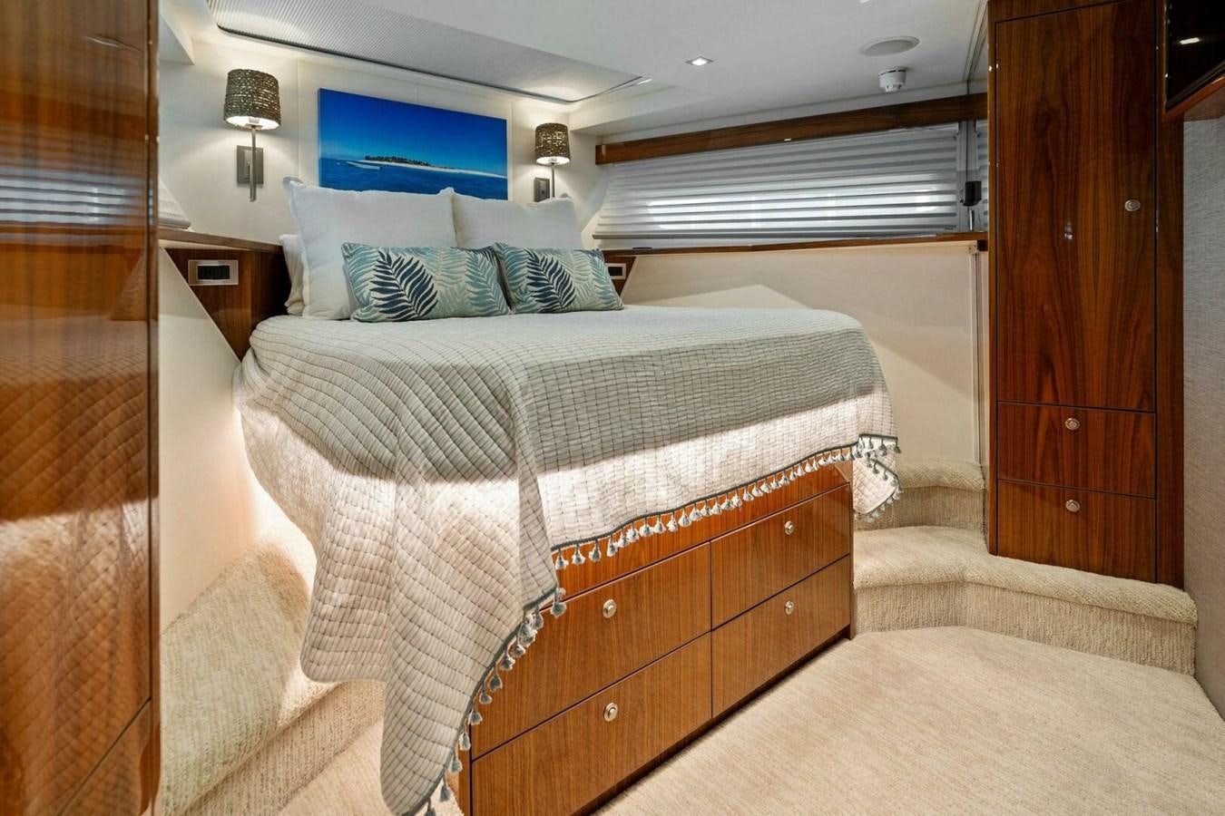 a room with a bed and a wood door aboard MANA Yacht for Sale