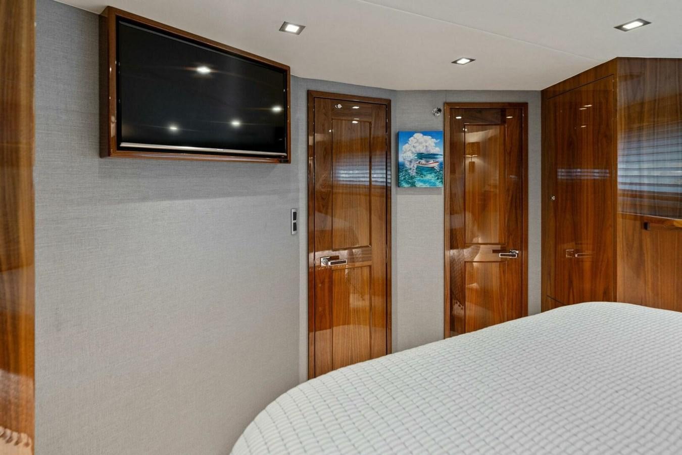 a hotel room with a bed and tv aboard MANA Yacht for Sale