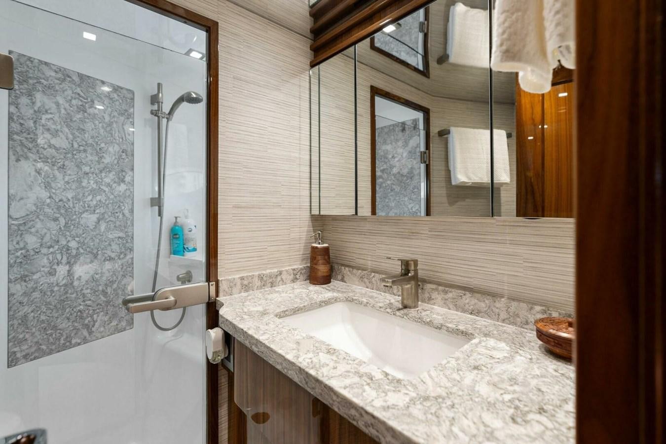 a bathroom with a sink and mirror aboard MANA Yacht for Sale
