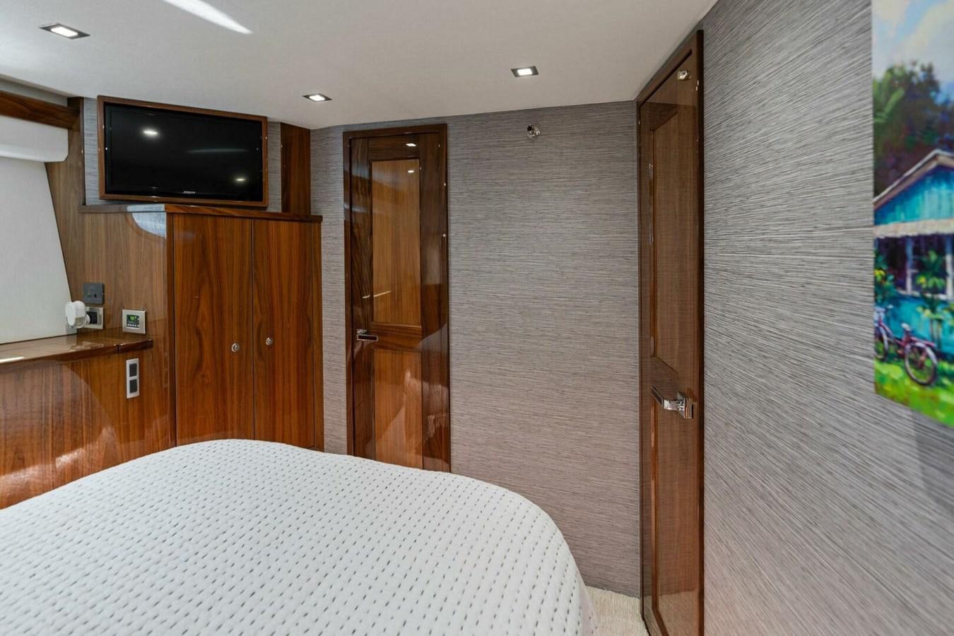 a hotel room with a television and bed aboard MANA Yacht for Sale