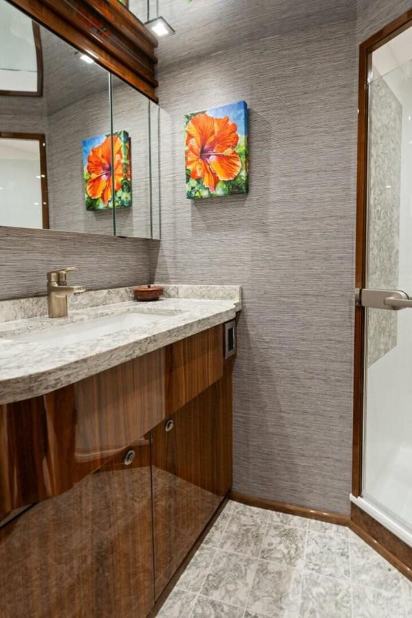 a bathroom with a large mirror aboard MANA Yacht for Sale