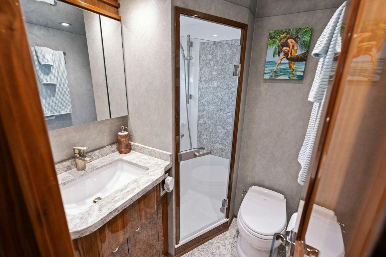 a bathroom with a toilet and a sink aboard MANA Yacht for Sale