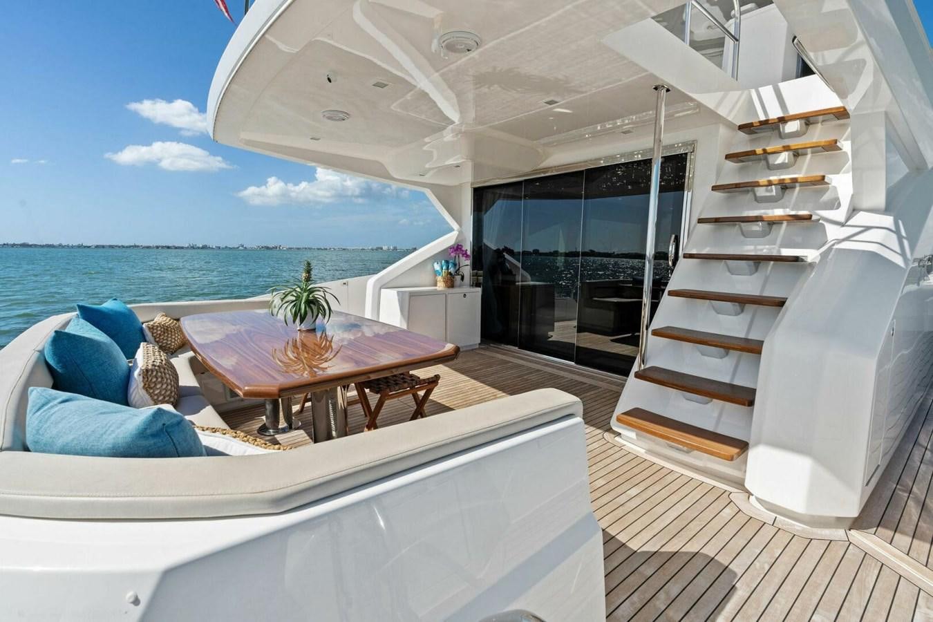 a room with a bed and a table and a chair aboard MANA Yacht for Sale