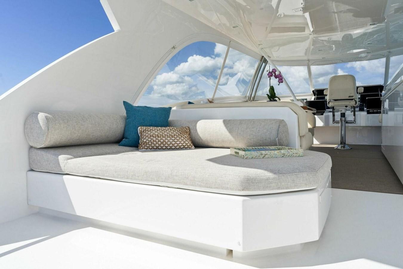 a white couch with a blue pillow aboard MANA Yacht for Sale