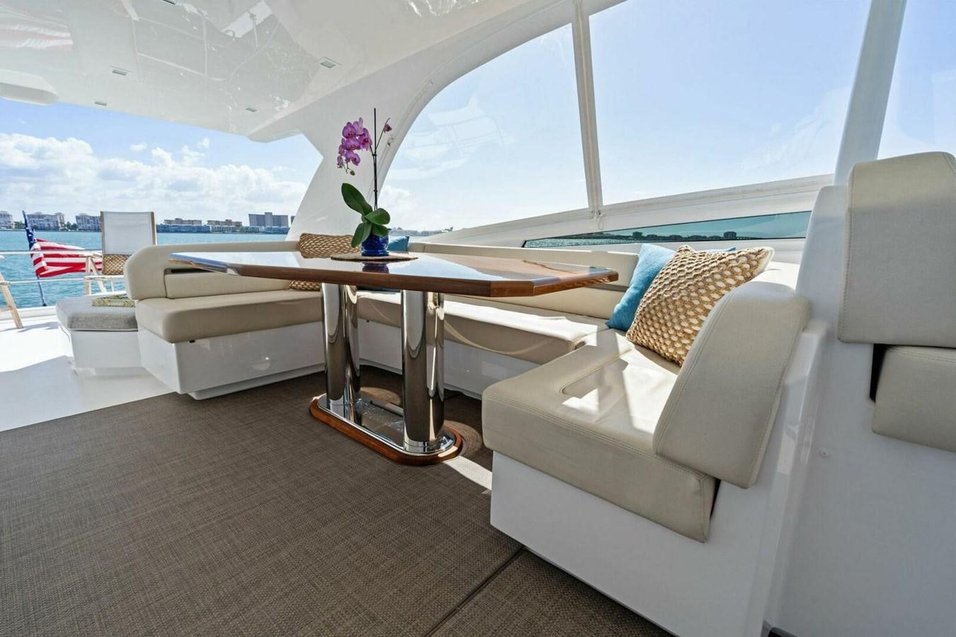 a room with a table and chairs aboard MANA Yacht for Sale