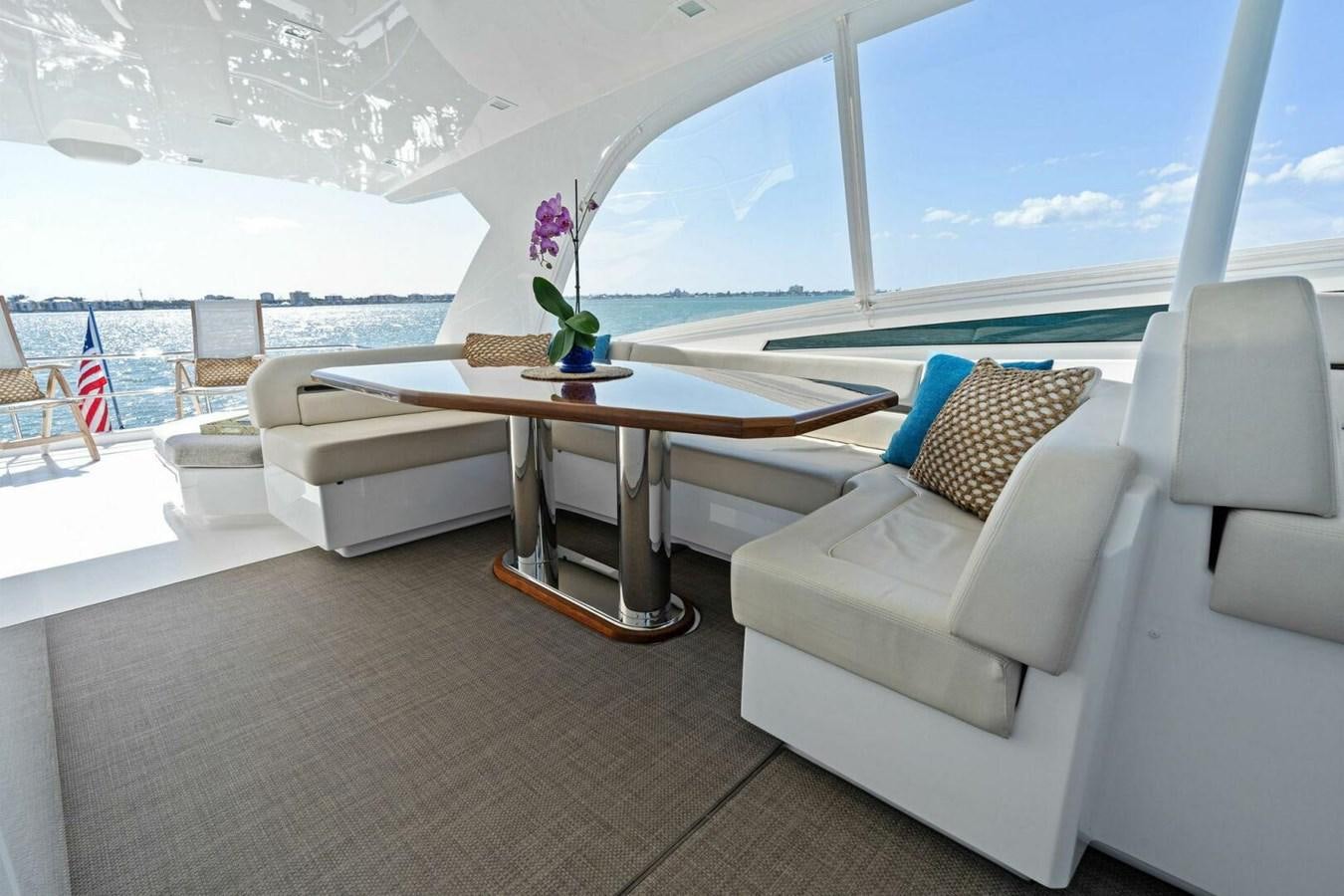 a room with a table and couches aboard MANA Yacht for Sale
