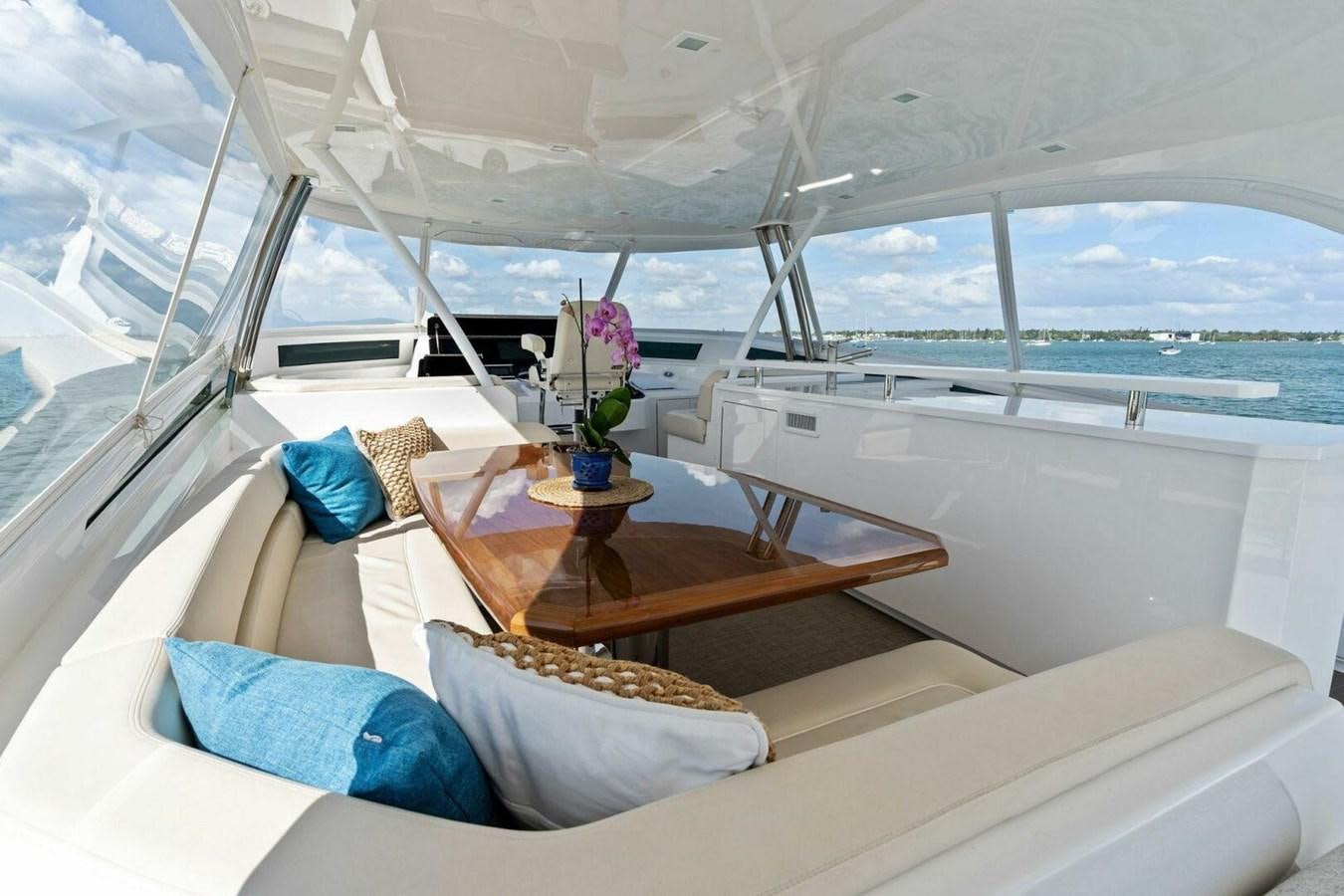 a boat with a table and chairs aboard MANA Yacht for Sale
