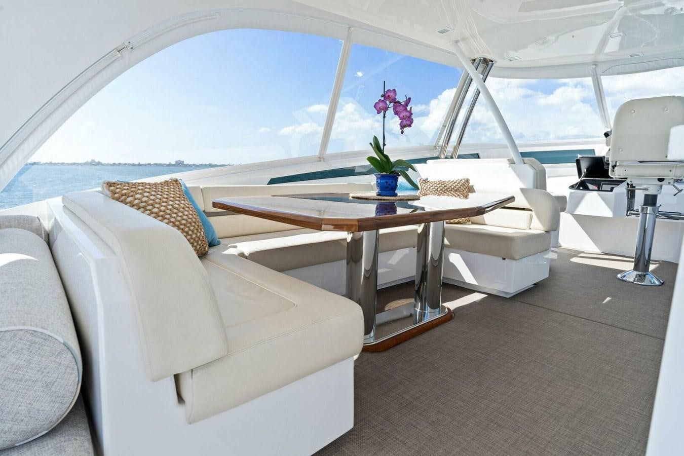 a room with a table and chairs aboard MANA Yacht for Sale