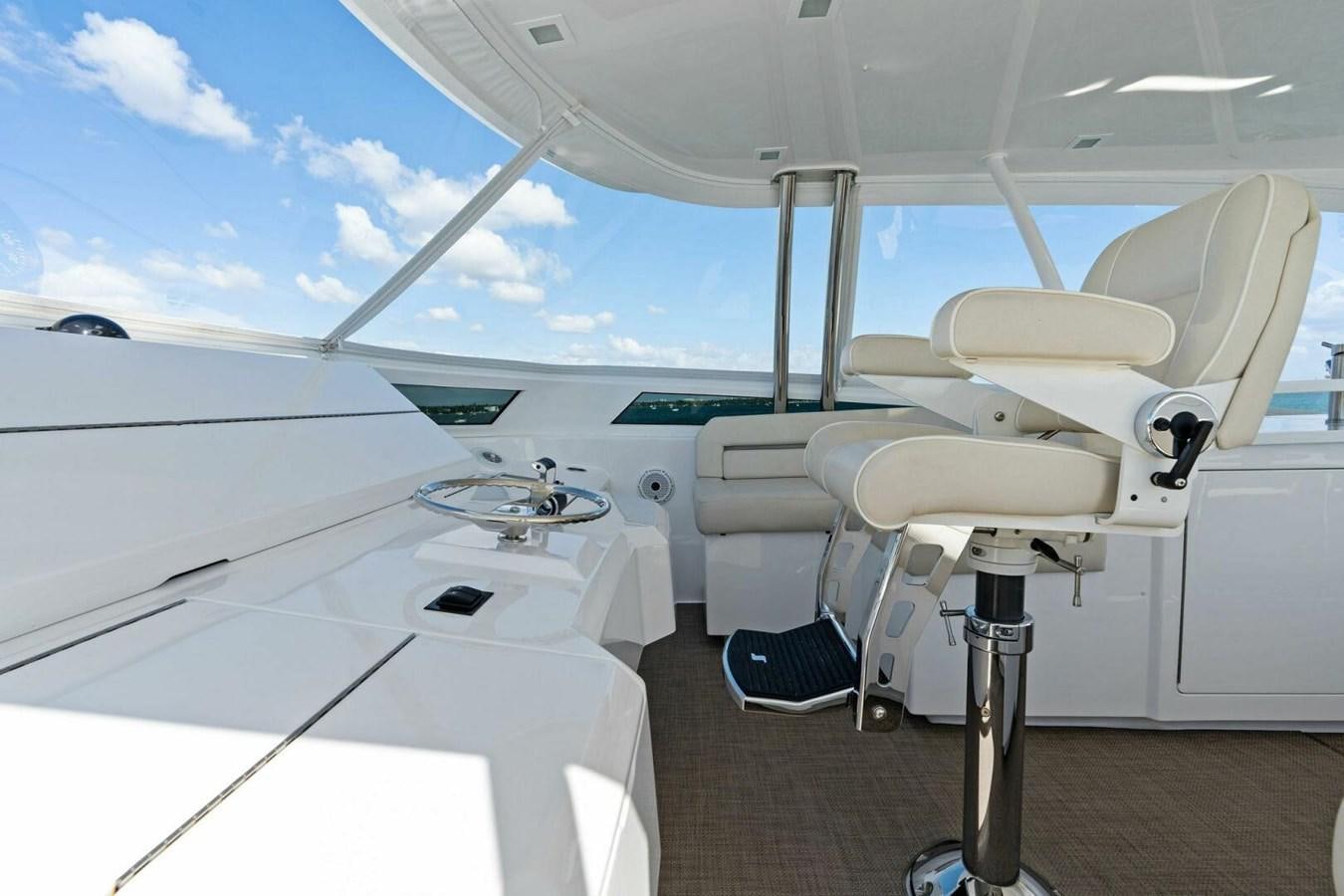 a white yacht with chairs aboard MANA Yacht for Sale