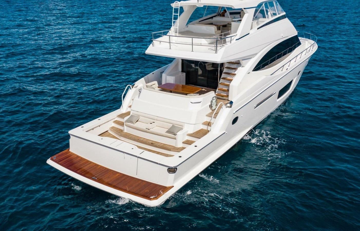 a white boat on the water aboard MANA Yacht for Sale