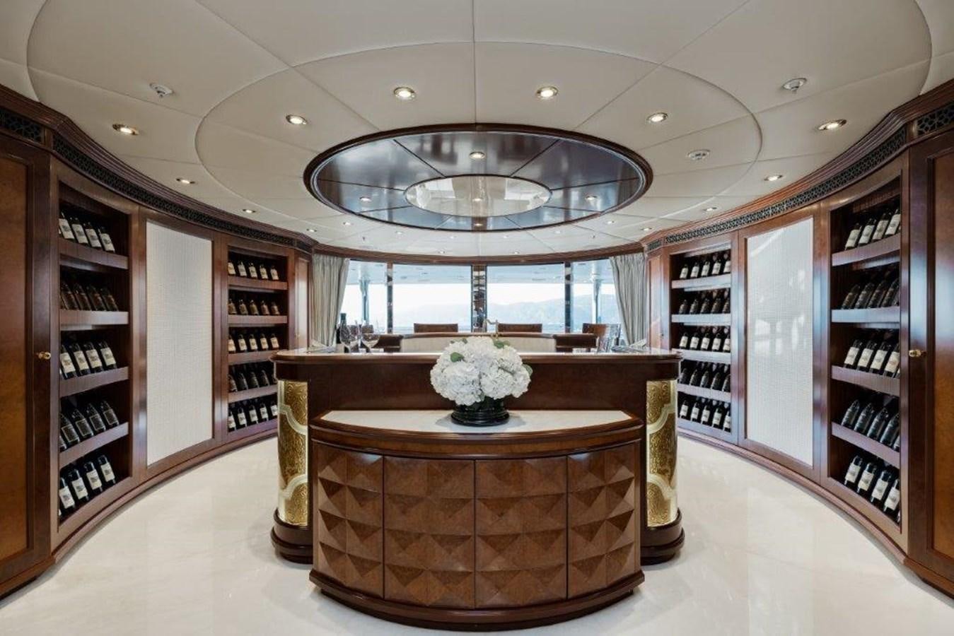 a room with a table and a shelf with books aboard IRON BLONDE Yacht for Sale