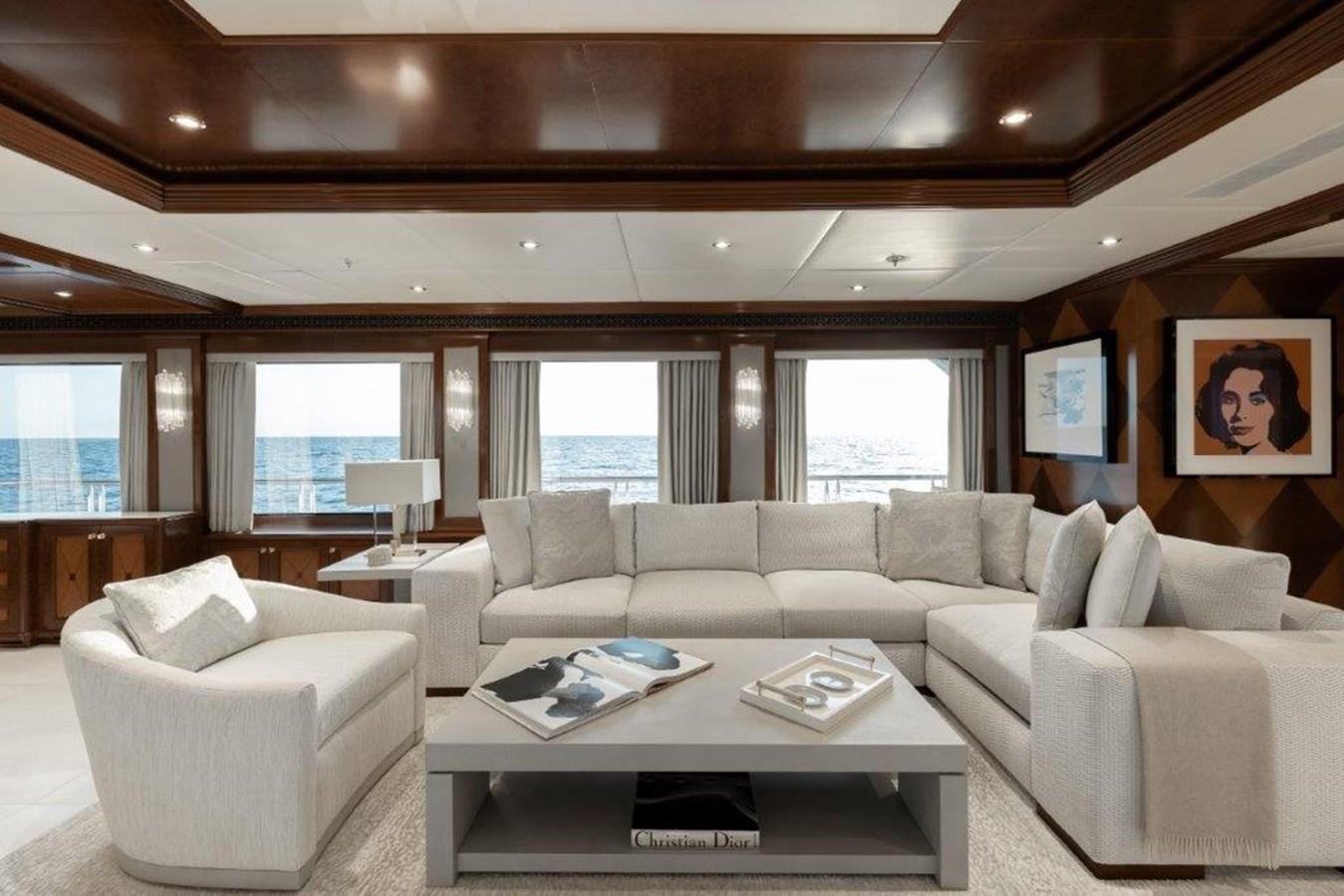 a living room with a white couch and a coffee table aboard IRON BLONDE Yacht for Sale
