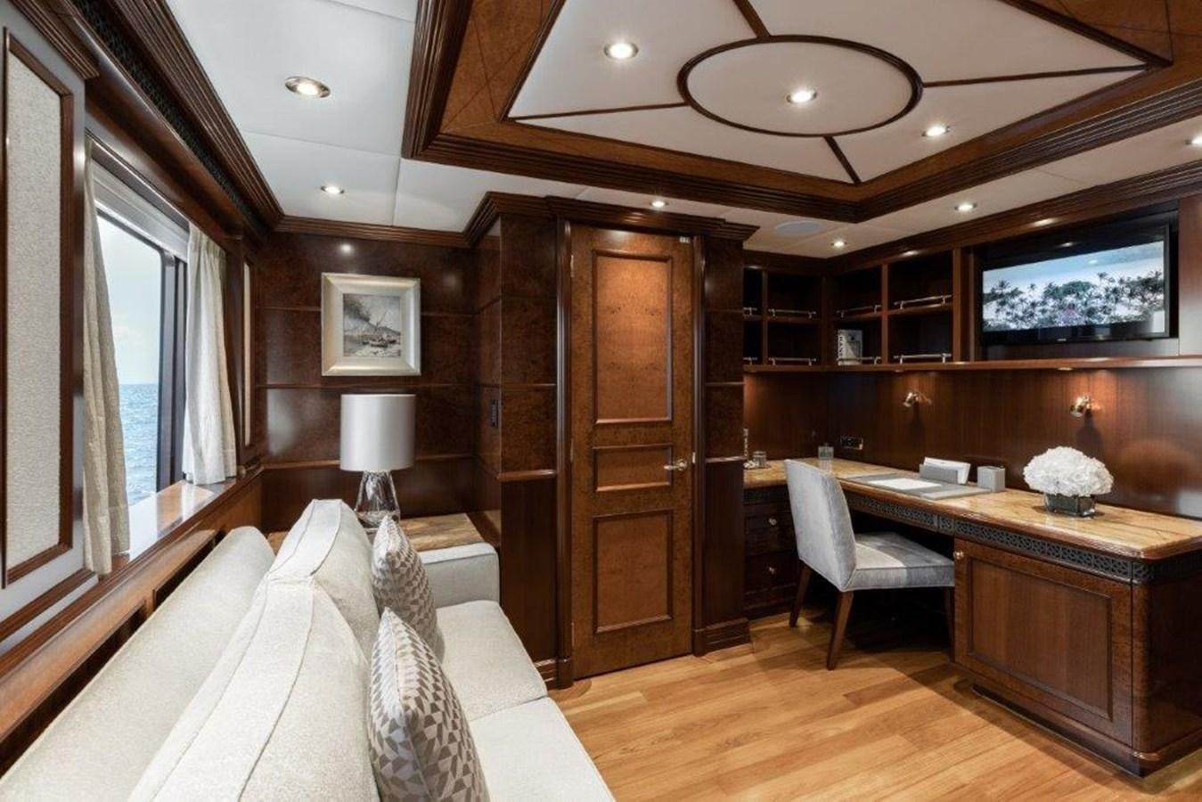 a room with a desk and a bed aboard IRON BLONDE Yacht for Sale