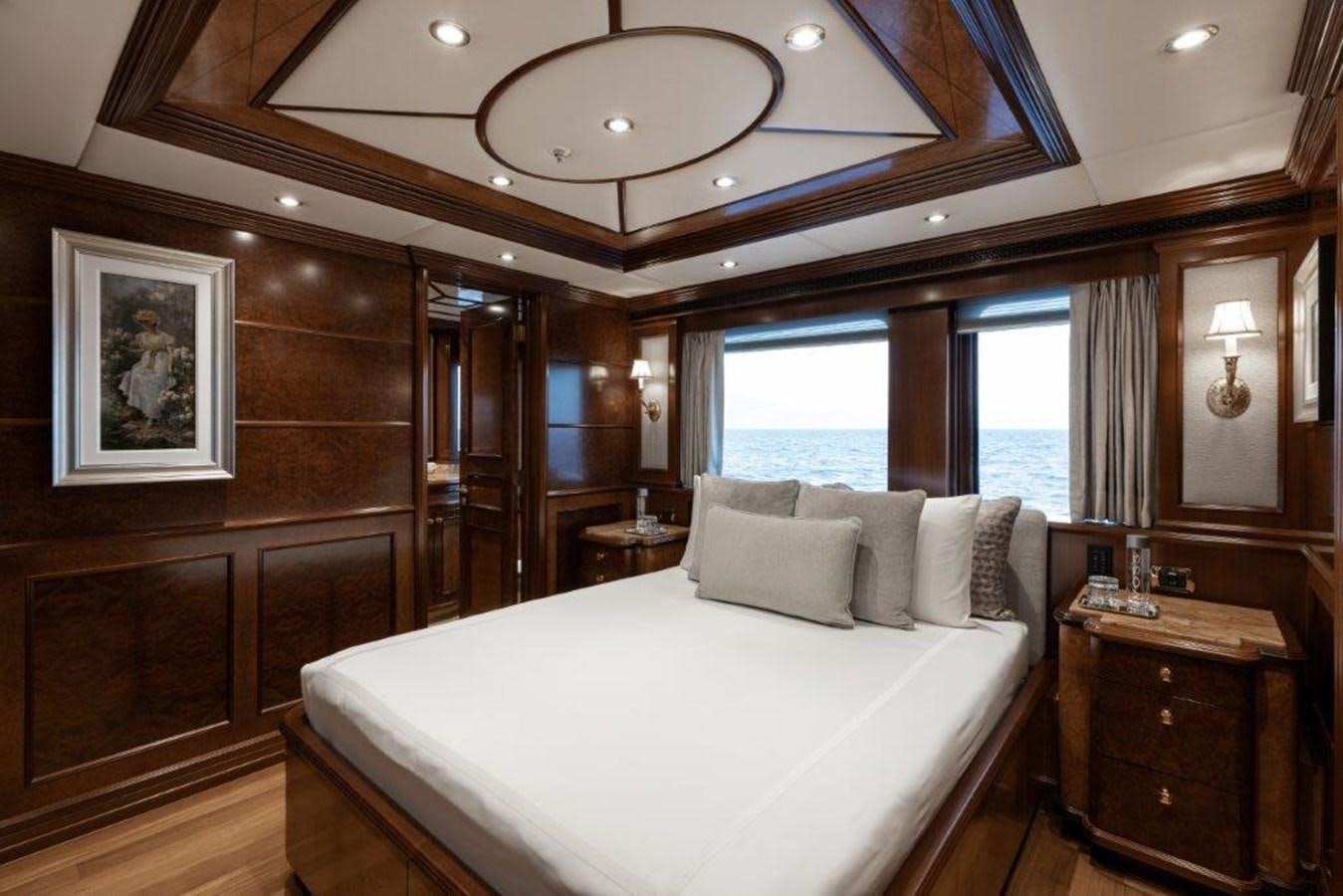 a large bedroom with a large bed aboard IRON BLONDE Yacht for Sale