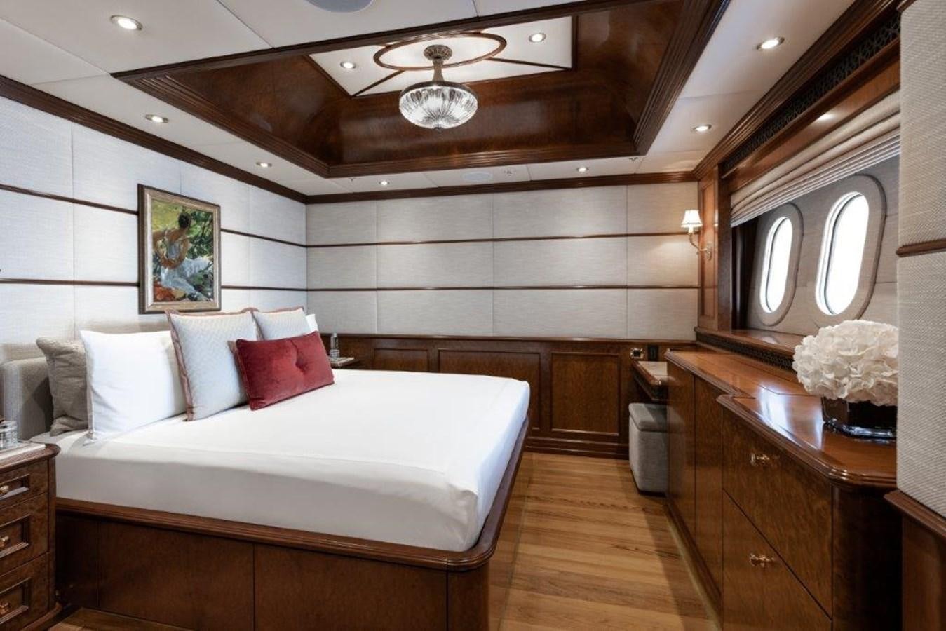 a room with a bed and a mirror aboard IRON BLONDE Yacht for Sale