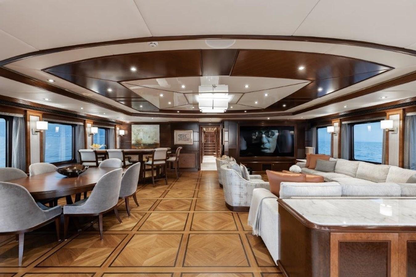 a large living room with a table and chairs aboard IRON BLONDE Yacht for Sale