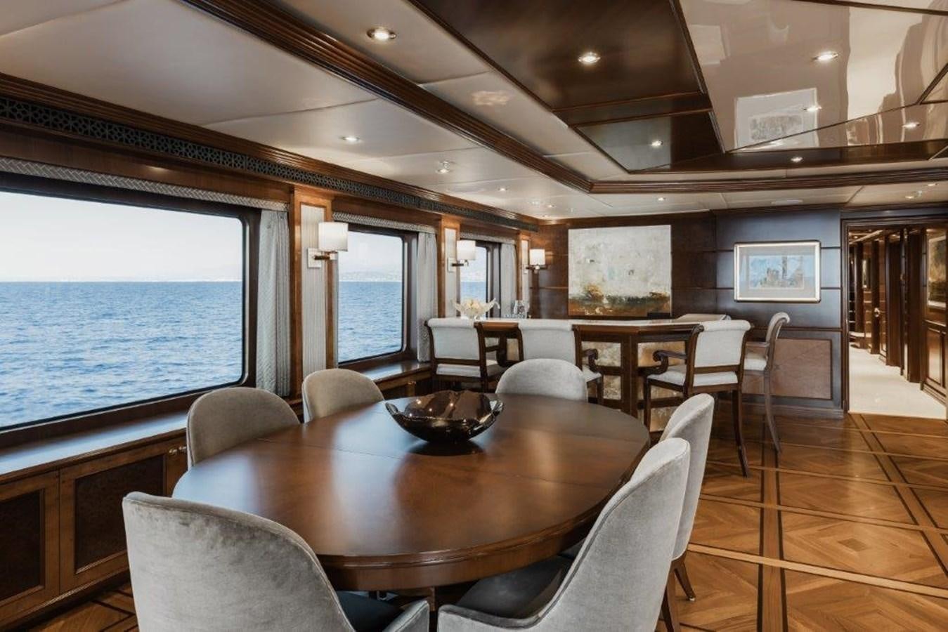 a large room with a table and chairs aboard IRON BLONDE Yacht for Sale