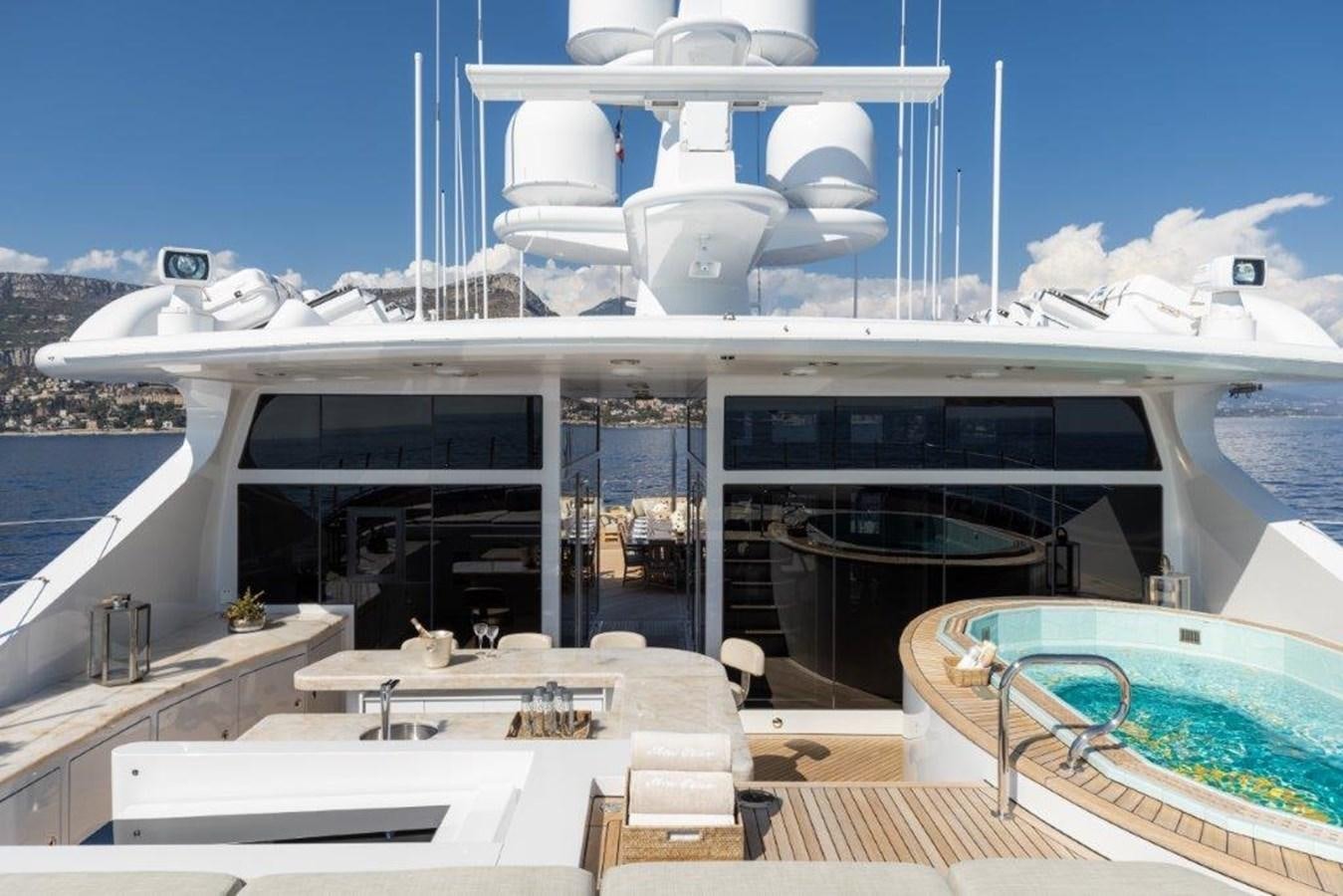 a large white building with a pool aboard IRON BLONDE Yacht for Sale