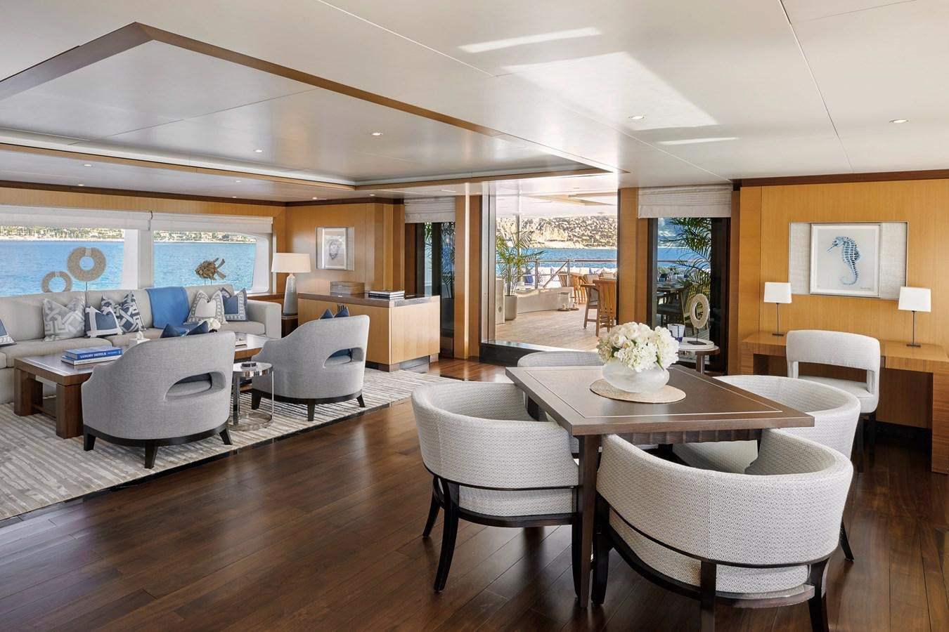 a living room with white chairs and a table aboard LA BLANCA Yacht for Sale