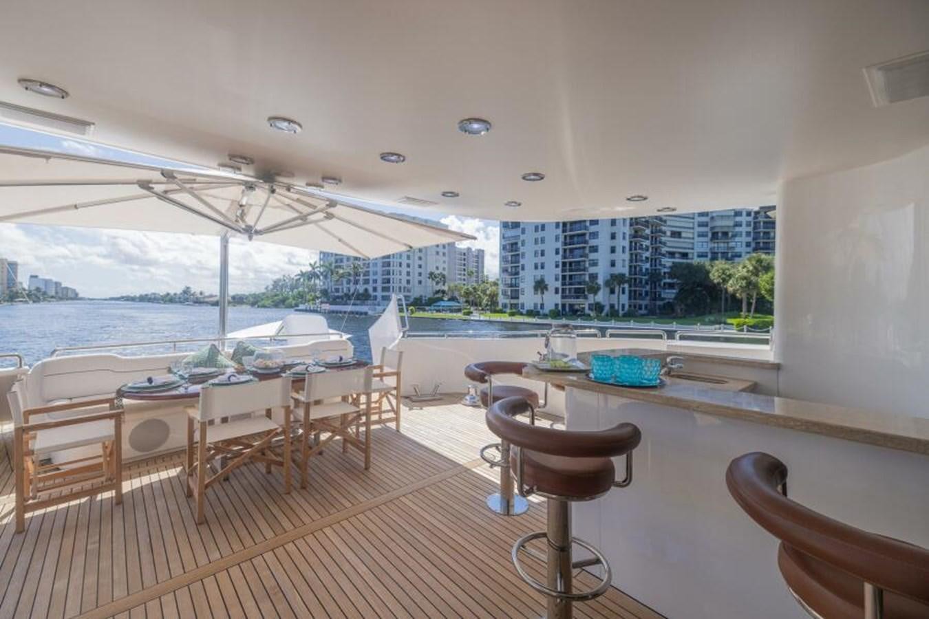 a room with tables and chairs aboard ENTOURAGE Yacht for Sale