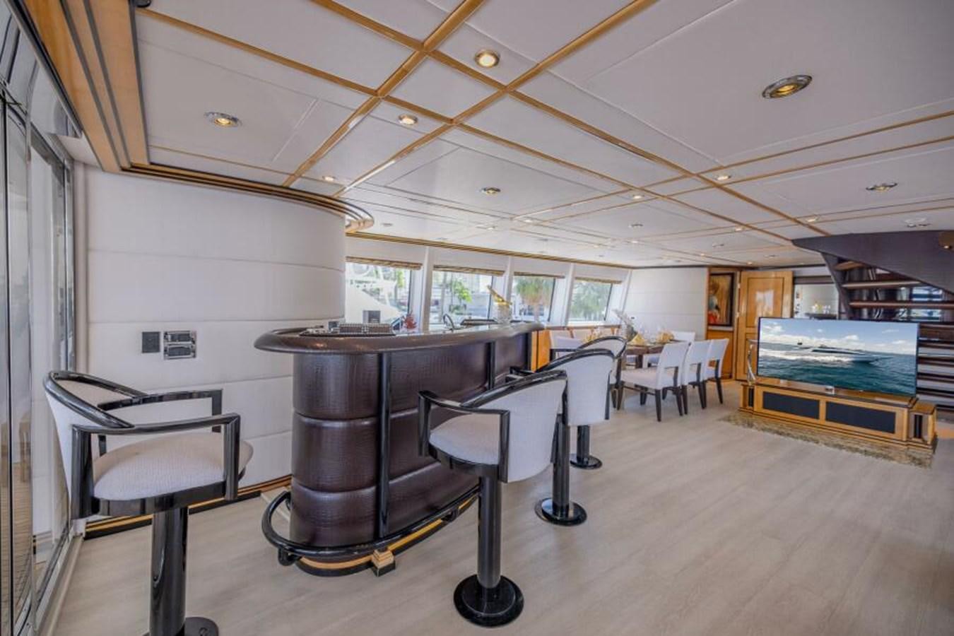 a room with a table and chairs aboard ENTOURAGE Yacht for Sale