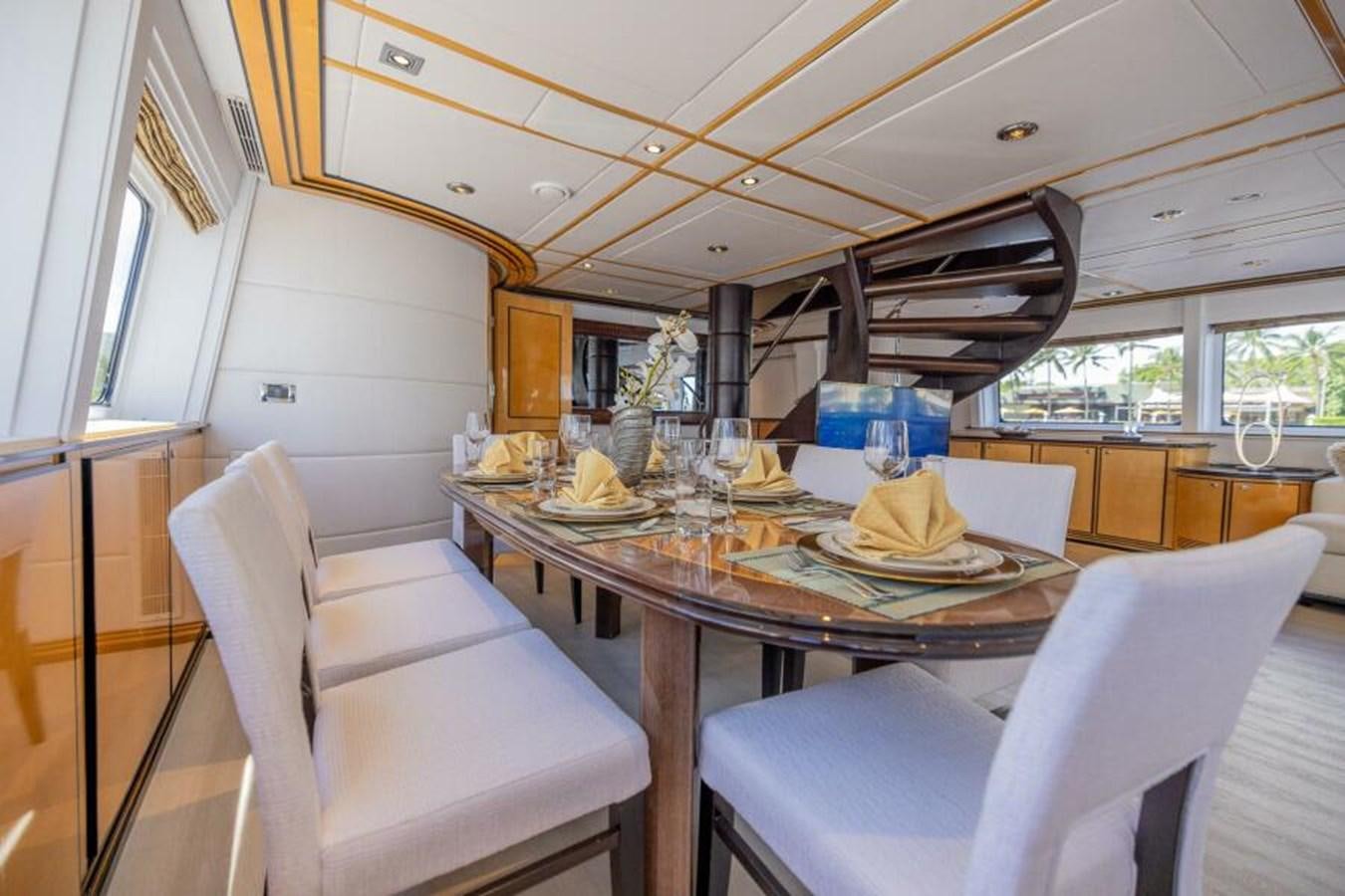 a dining table with chairs aboard ENTOURAGE Yacht for Sale